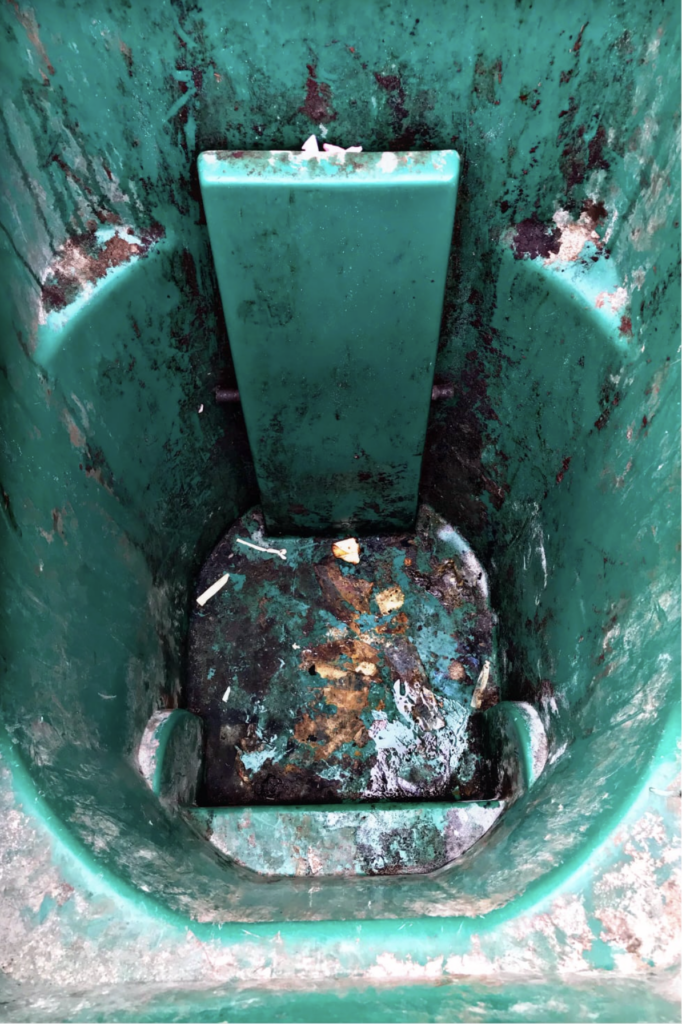 Dirty garbage bin before cleaning